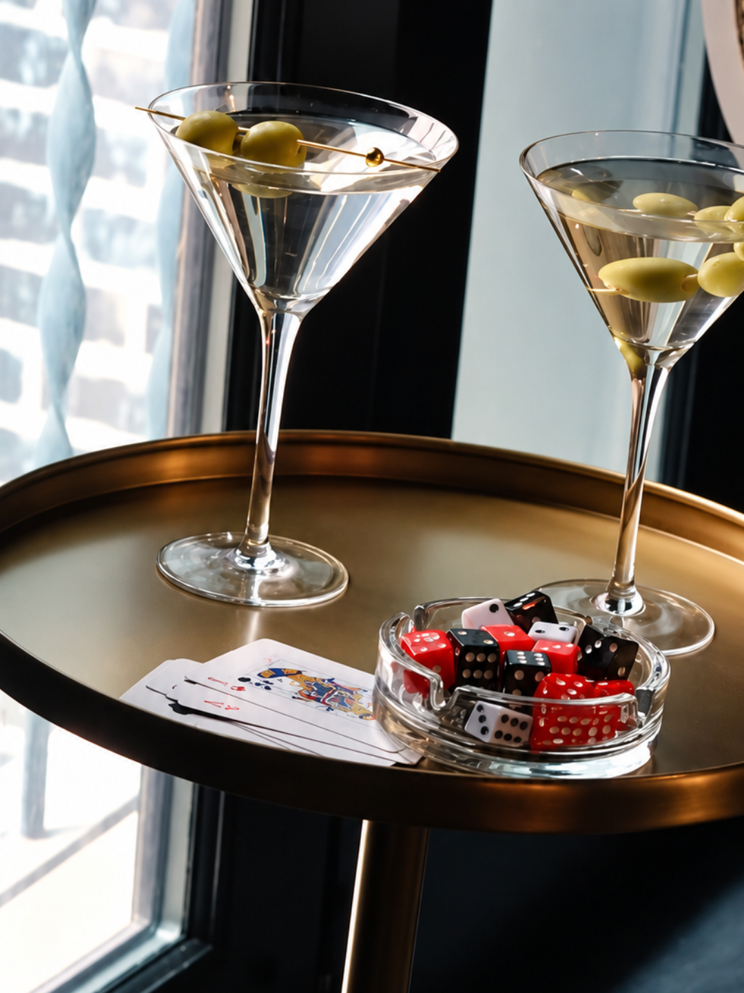 Martinis, playing cards and dice on a gold table